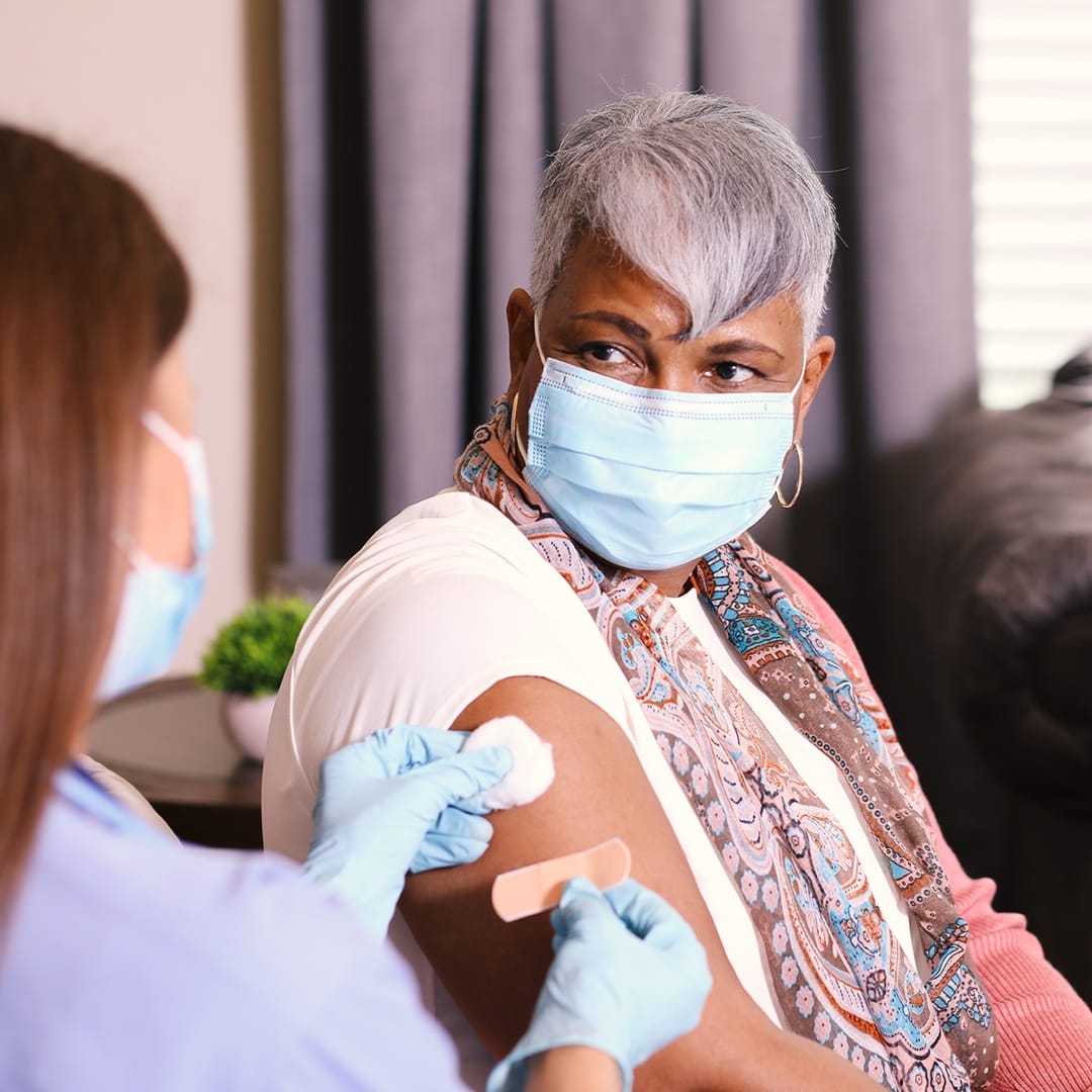 Elderly woman getting COVID-19 Vaccine